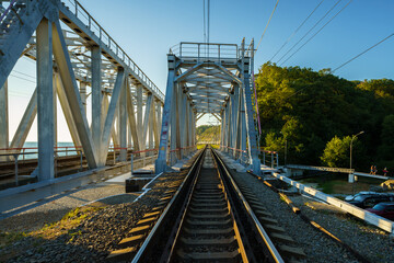Obraz premium Train railway with steel Bridge near the beach.