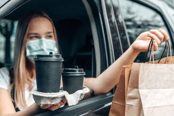 Contactless delivery. Girl Courier with food takeaway zero waste paper packaging delivers...
