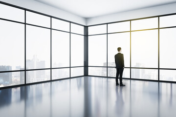 Fototapeta na wymiar Businessman standing in modern office interior with panoramic city view.