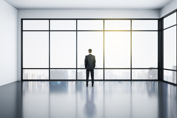 Fototapeta premium Businessman standing in modern office interior