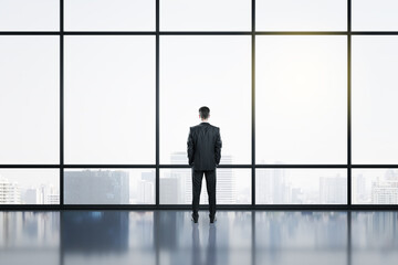 Fototapeta na wymiar Businessman standing in contemporary office hall