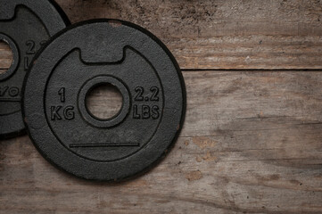 Dumbbell discs for weight lifting on wooden floor