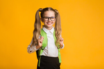 Schoolgirl Posing With Backpack Standing In Studio Smiling To Camera