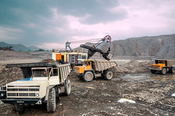 Mining trucks transport mountain soil for further processing © Letopisec