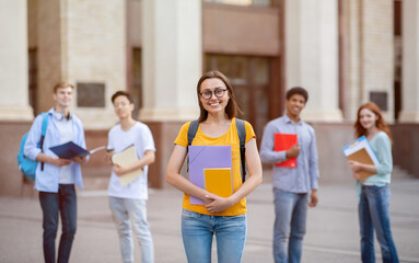 Obraz premium Student Girl Standing Near University Building Outdoors, Posing With Backpack