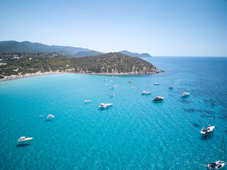 aerial view of sardinia shoreline with boat and crystal clear blue turquoise sea - (Mari pintau - Painted Sea ) TRAVEL in SARDINIA.