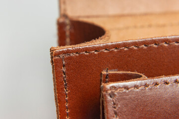 Fashionable brown women's bag made of genuine leather close-up. Fashion concept. Details of leather...