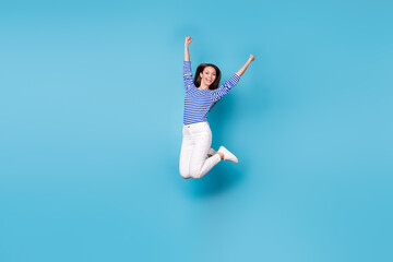 Fototapeta na wymiar Full length body size view of her she nice attractive pretty cheerful cheery lucky successful girl jumping having fun rejoicing isolated bright vivid shine vibrant blue color background
