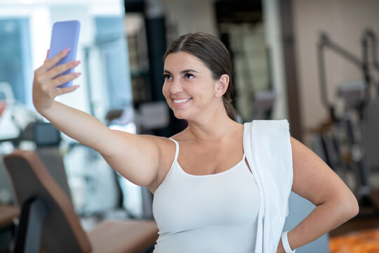 Confident woman making a selfie in a gym