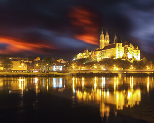 Fototapeta na wymiar Dramatic view on Albrechtsburg castle and cathedral on the River Elbe during night.