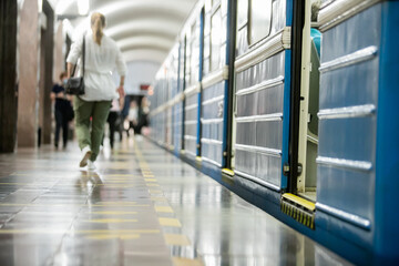 People get off the train car in the subway