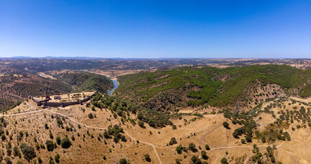 Noudar medieval castle aerial panorama, with Alentejo landscape background. and Located 5 kilometres from the Spanish border. Alentejo, Portugal.