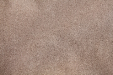 Beige suede leather texture. The cloth.