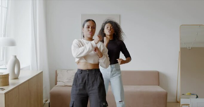 Two African-American Black girls recording trendy dance moves for social media account