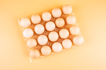 Eggs in a plate on yellow background