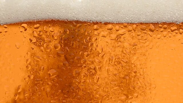 Close up background of beer with bubbles in glass