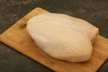 Raw whole chicken breast with skin