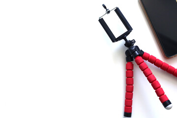 Mobile phone and tripod on white background.Smart phone new technology dedicated for live streaming. Blogger equipment.