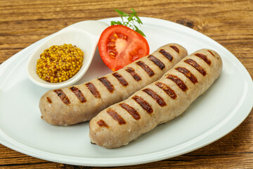 Grilled natural pork sausages with sauce