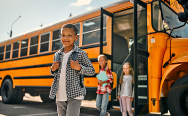 Children near school bus - Powered by Adobe
