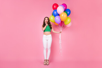 Full length photo of astonished girl hold many balloons present gift for festive occasion party wear trousers isolated over pink color background