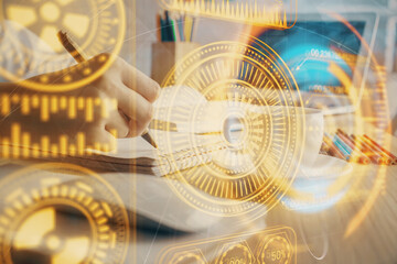 Tech theme hologram over woman's hands taking notes background. Concept of hightech. Double exposure