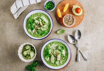 Cold green soup Gazpacho with cucumber, green peas, basil leaves and avocado.