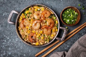 A traditional dish of Asian cuisine. Rice with shrimps, green onion and yellow corn