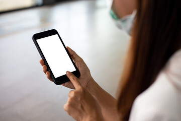 Mockup image of asian woman hand using smartphone In the coffee shop,Screen blank with clipping path
