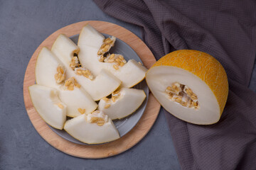 melon, melon wedges with seeds in a plate on the table, farm harvest. background. position in the center