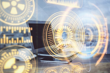 Technology theme hologram with man working on computer on background. High tech concept. Multi exposure.