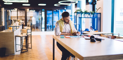 Man working with documents in creative contemporary cafe