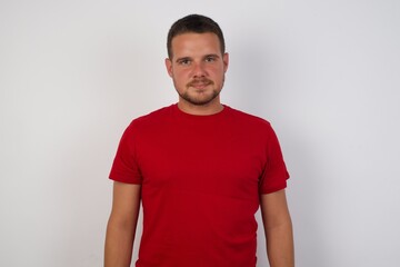 Fototapeta premium Young caucasian man with short hair wearing colorful shirt over isolated white background with a happy and cool smile on face. Lucky person.
