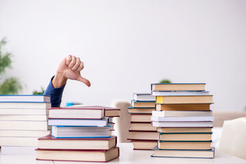 Young male student preparing for exams at home