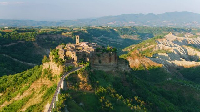 Aerial footage of medieval city on the rock,  Civita di Bagnoregio  illuminated by setting sun. Italy. Apple ProRes codec.