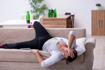 Fototapeta premium Young male alcoholic drinking wine at home