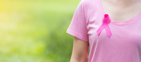 October Breast Cancer Awareness month, adult Woman in pink T- shirt and Pink Ribbon for supporting...