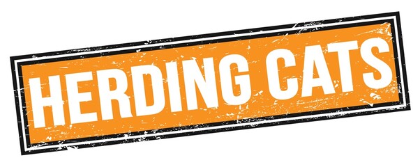 Fototapeta premium HERDING CATS text on orange black grungy rectangle stamp.