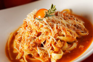 Noodles in tomato sauce and parmesan cheese.