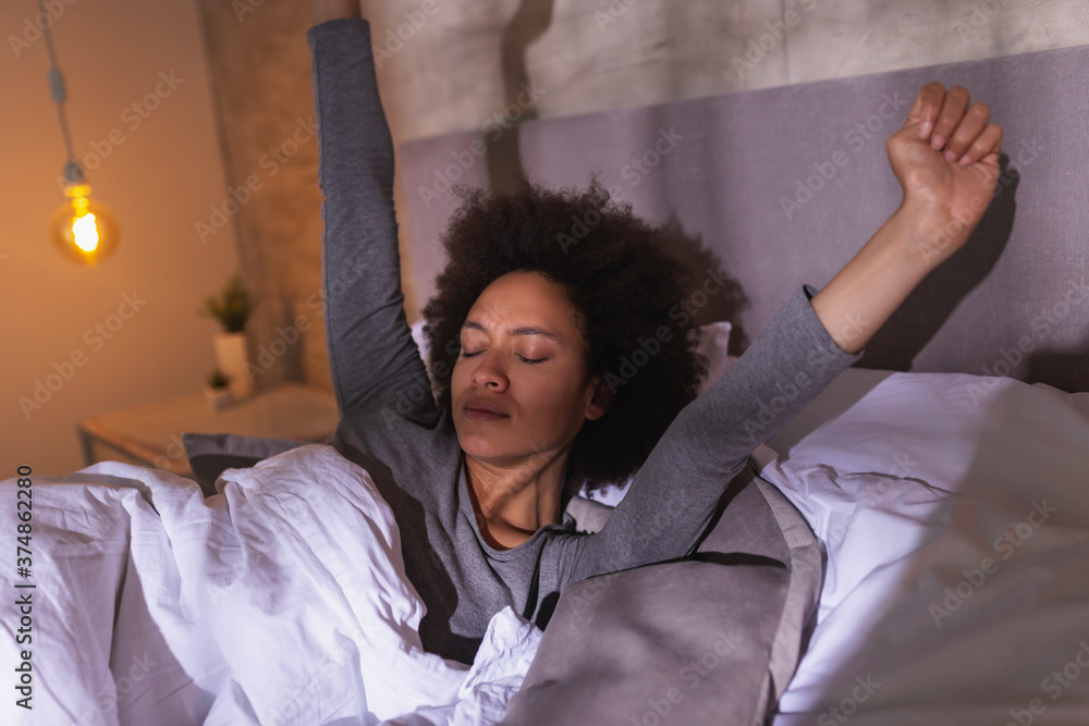 Sticker Woman stretching in bed after waking up