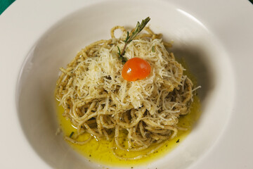 Spaghetti with green tomato sauce, Parmesan cheese and Cherry tomato.