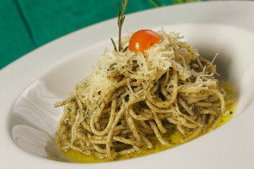 Spaghetti with green tomato sauce, Parmesan cheese and Cherry tomato.