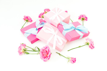 Floral composition of pink roses flowers and gifts on white background. Flat lay
