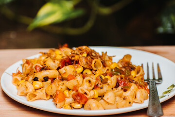 Pasta with fork on wooden background. with space for text