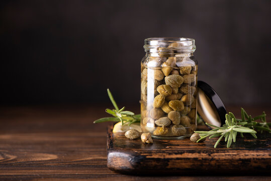 pickled capers in a glass jar with herbs