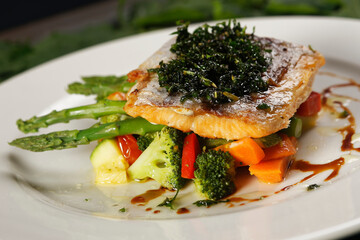 Smoked salmon with chimichurri and vegetable garnish with pumpkin, carrot, broccoli and asparagus.