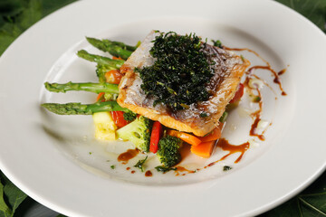 Smoked salmon with chimichurri and vegetable garnish with pumpkin, carrot, broccoli and asparagus.