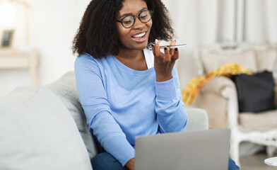 Young woman using voice assistant on smart phone