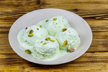Pistachio ice cream on wooden table