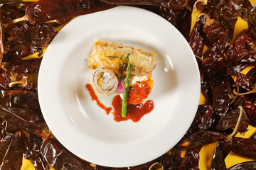 Chicken supreme stuffed with cream cheese with corn kernels and crispy mushroom patty seasoned with guajillo chili sauce and asparagus.